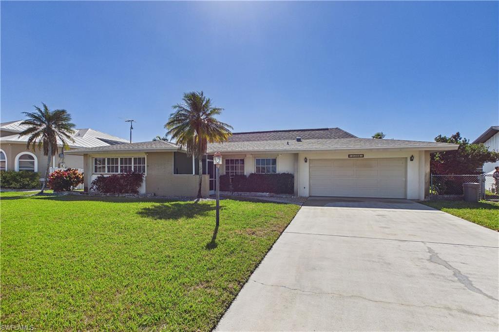 Ranch-style home with concrete driveway, a garage, and stucco siding