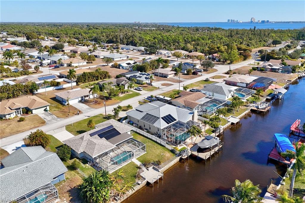 View of property location featuring a large body of water and nearby suburban area