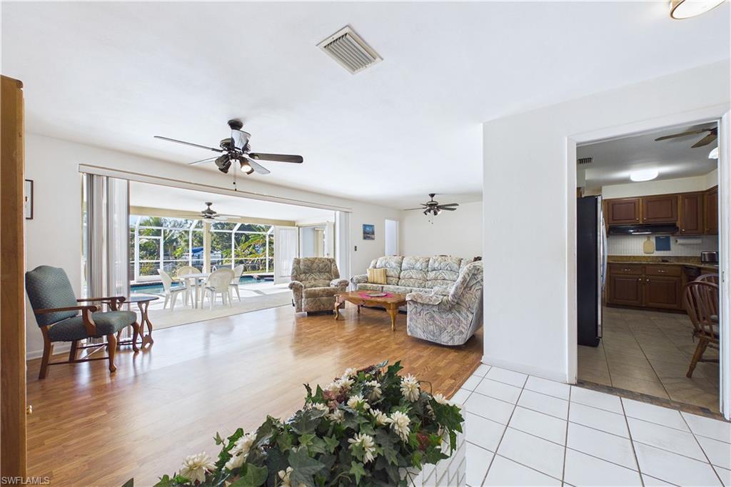 Living area featuring a ceiling fan and light wood-style flooring