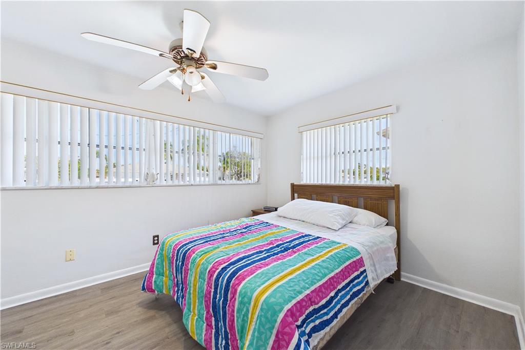Bedroom featuring dark wood-style floors and ceiling fan
