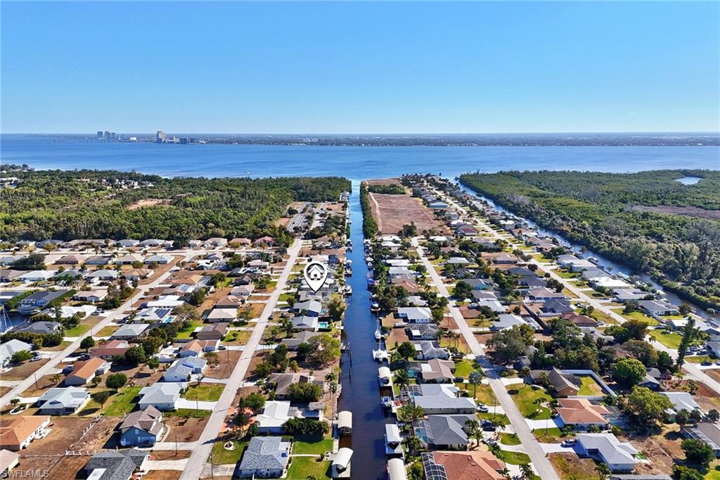 View of property location featuring a nearby body of water and nearby suburban area