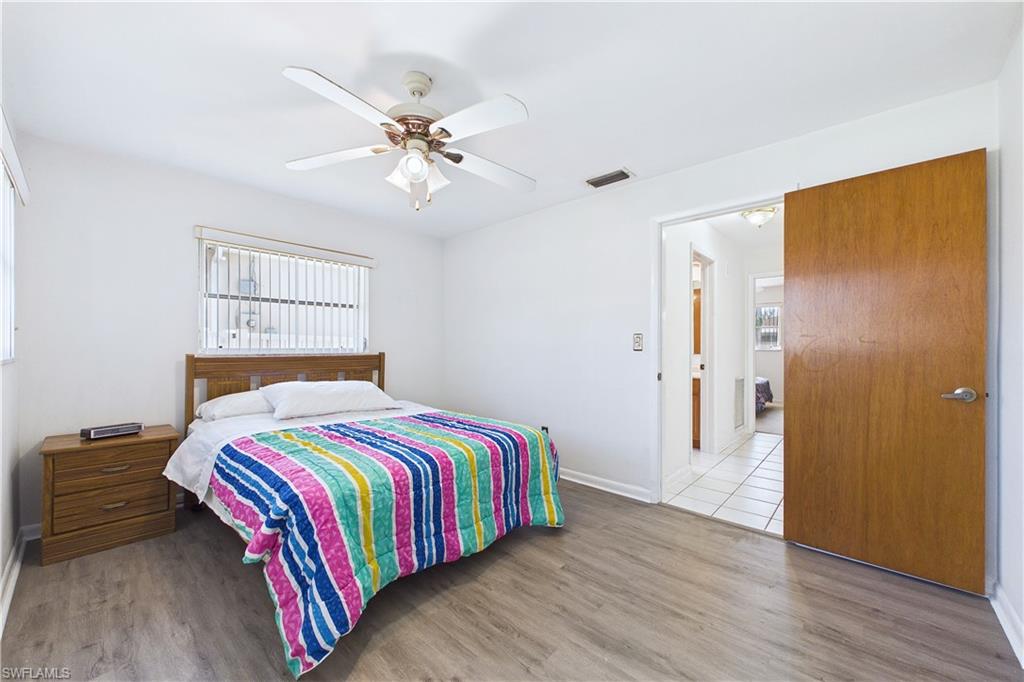 Bedroom featuring wood finished floors, ceiling fan, and multiple windows