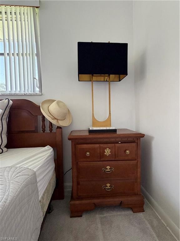 Wood-finish nightstand featuring three drawers with decorative brass pulls and a top surface