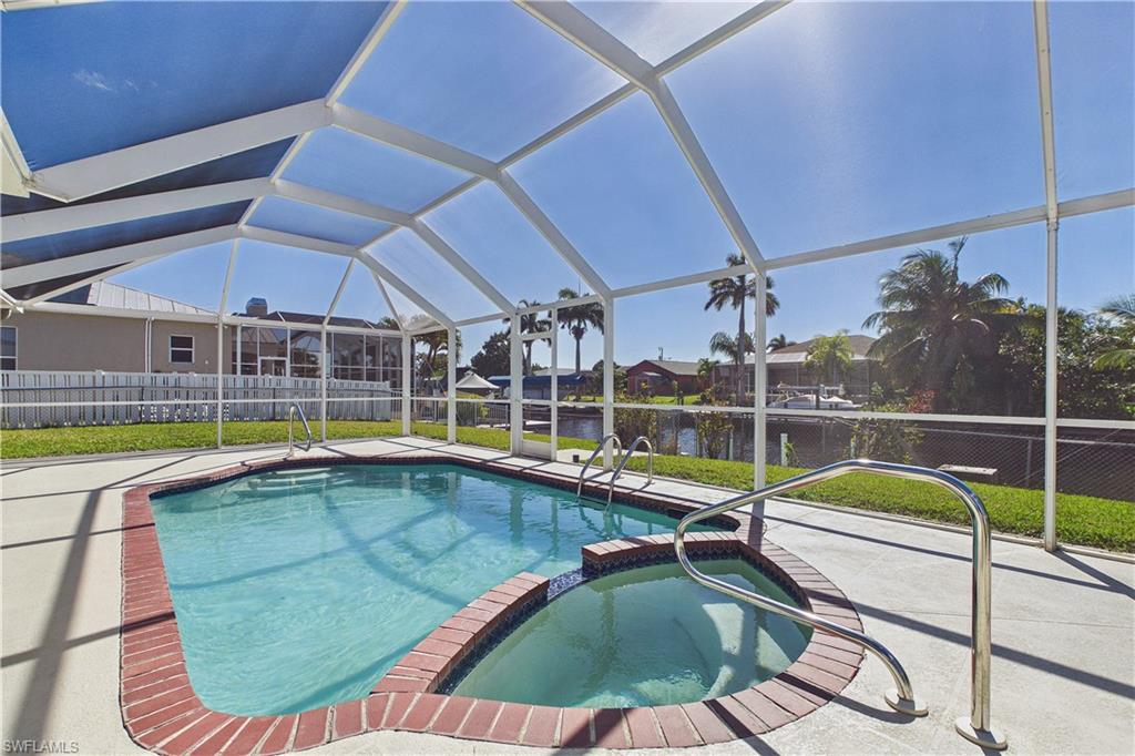 Combined pool / hot tub featuring a lanai, a sunroom, and a patio area