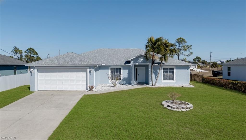 Single story home with stucco siding, concrete driveway, and an attached garage