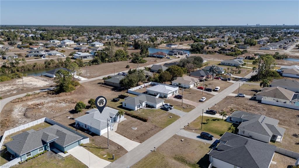 Aerial overview of property's location featuring nearby suburban area