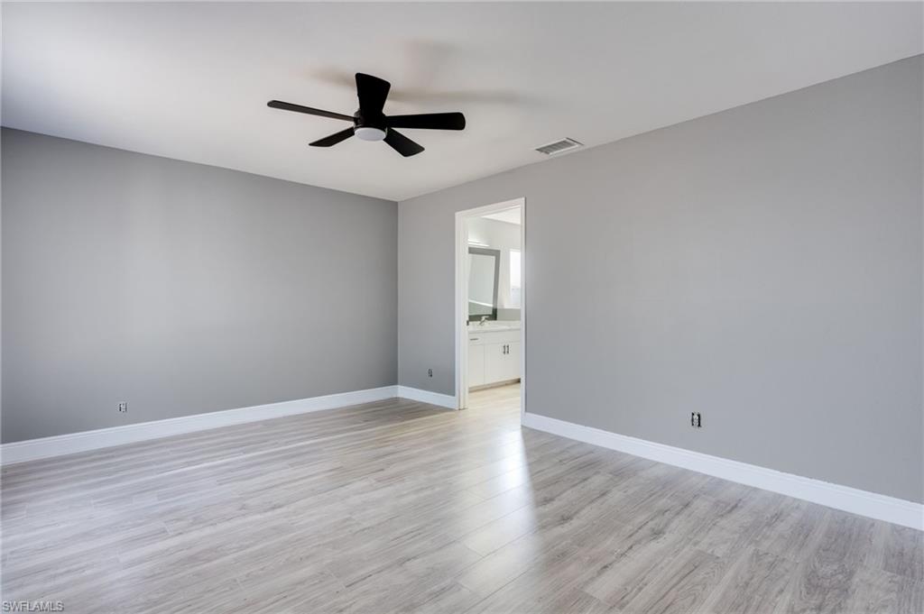 Spare room featuring ceiling fan and light wood-type flooring