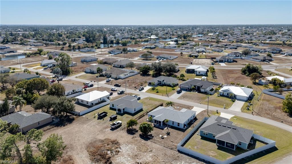 Aerial view of property's location with nearby suburban area