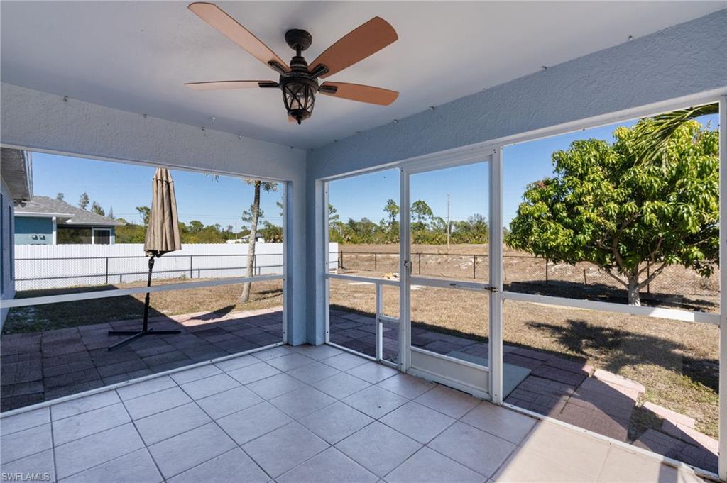 Unfurnished sunroom with ceiling fan and plenty of natural light