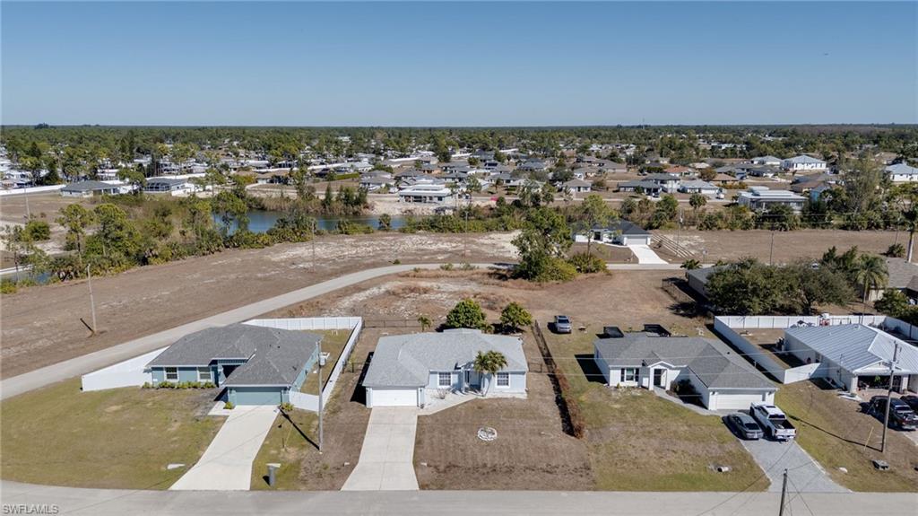 Aerial view of residential area featuring a nearby body of water