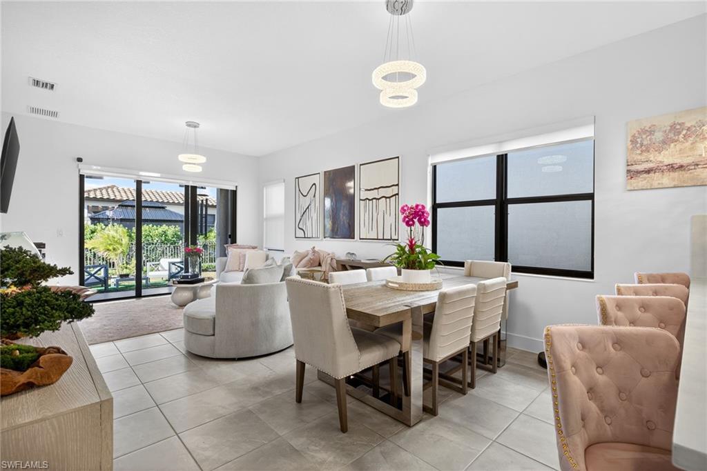 Dining space featuring light tile patterned floors