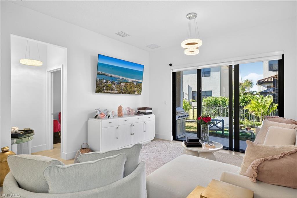 Living area featuring light wood-type flooring and baseboards