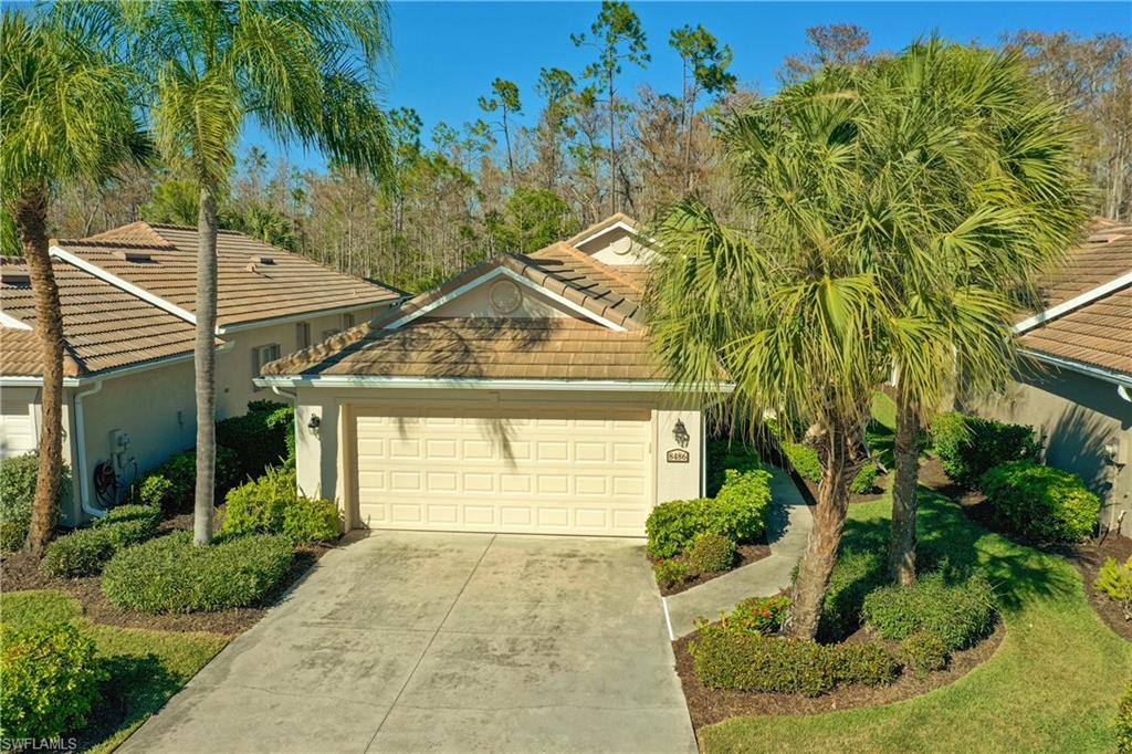View of front of house featuring stucco siding, concrete driveway, an attached garage, and a tile roof