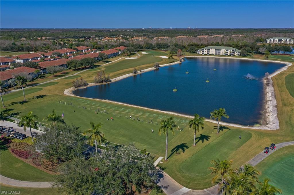 Aerial overview of property's location featuring a golf club and a nearby body of water