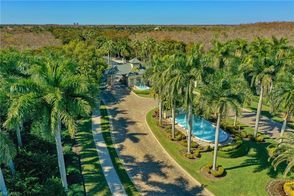 View of property location featuring a pool and a forest