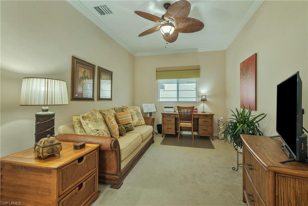 Living area featuring light colored carpet, ornamental molding, an office area, and ceiling fan