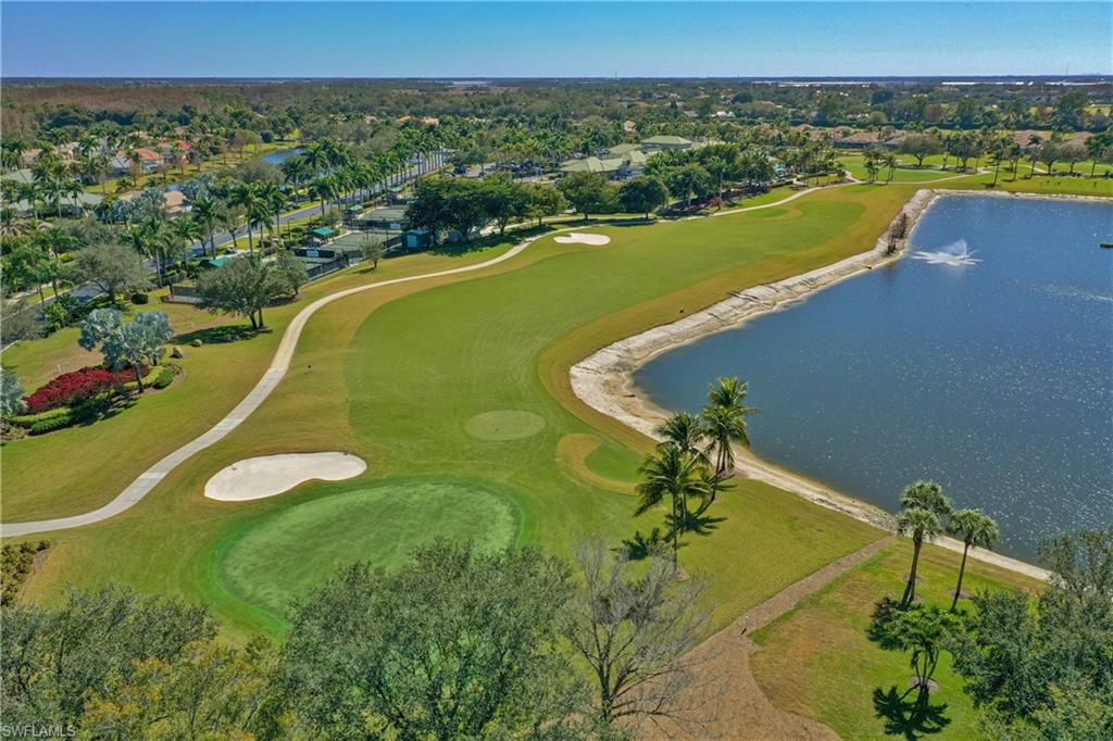 Aerial perspective of suburban area featuring a large body of water and a local golf course