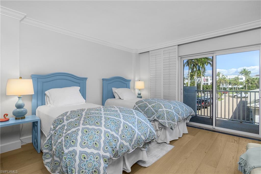 2nd Bedroom with crown molding, light wood finished floors, and access to exterior balcony