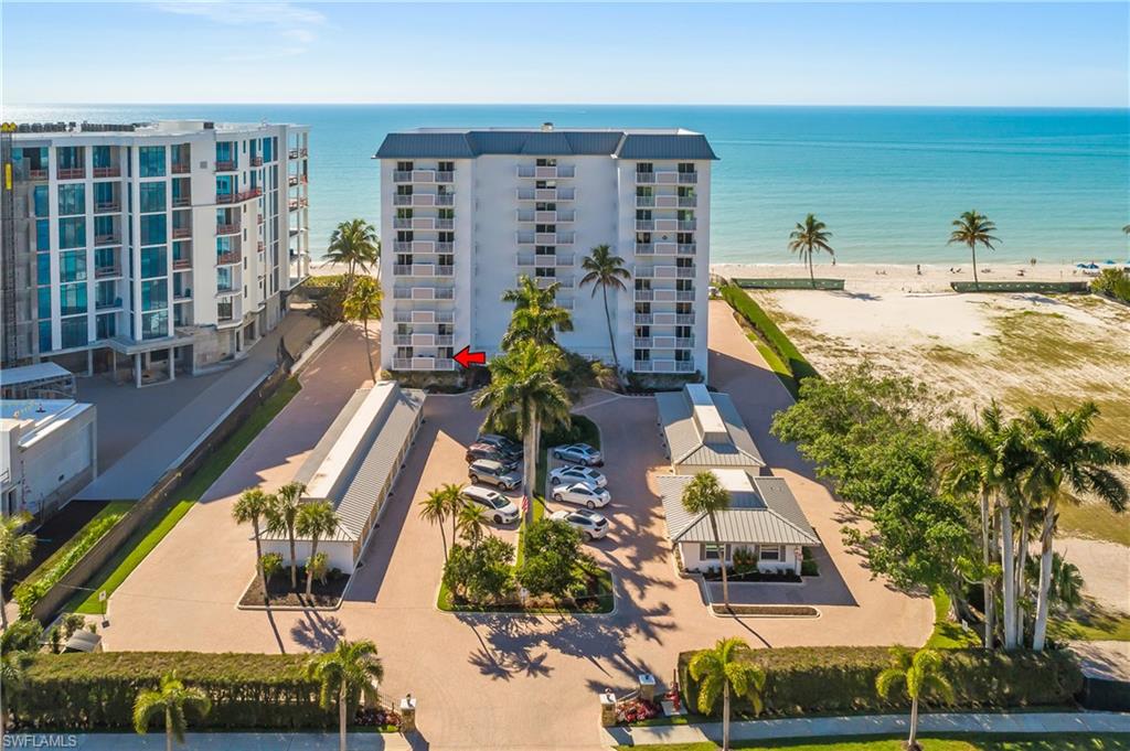 View of Embassy Club, building has ground floor parking and storage underneath building complex, featuring view of water and beach.