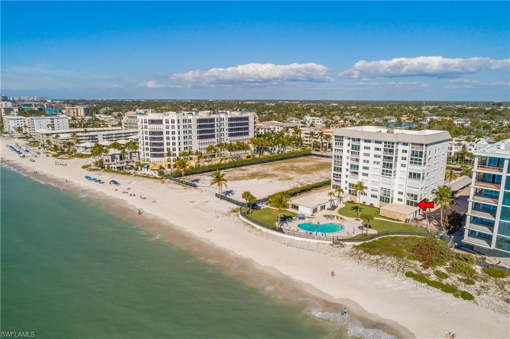 View of back of Embassy Club with beach front pool and expansive beach