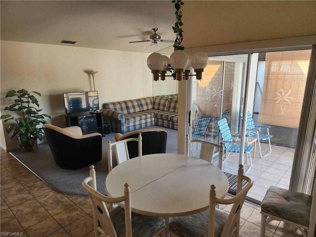 Dining area with ceiling fan and tile patterned floors
