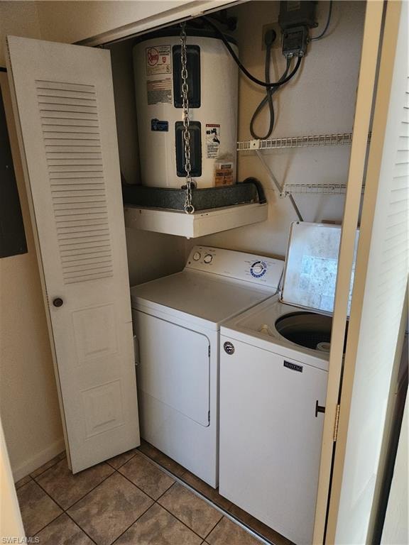 Laundry area featuring water heater and light tile patterned floors