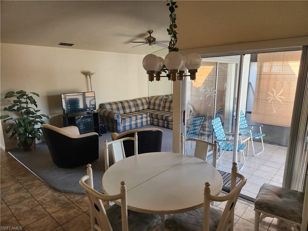 Dining space with ceiling fan and tile patterned flooring