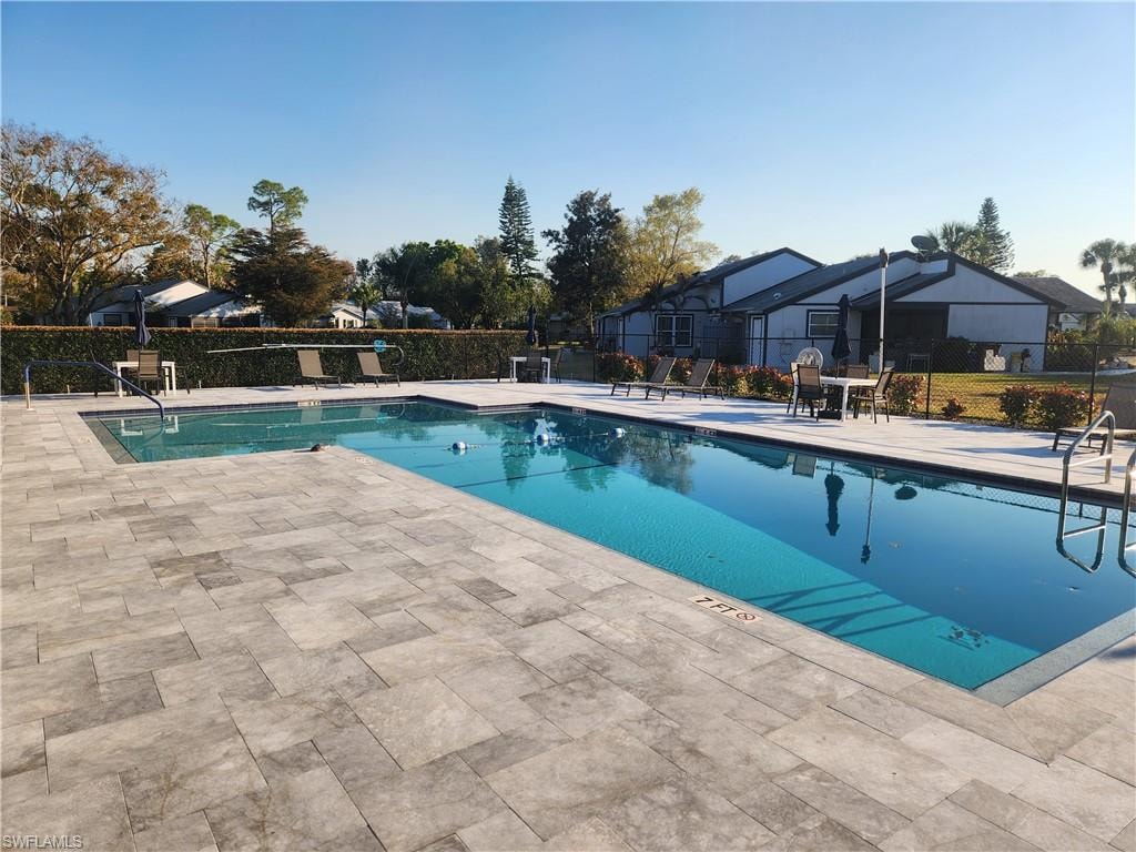 Community pool with a patio area