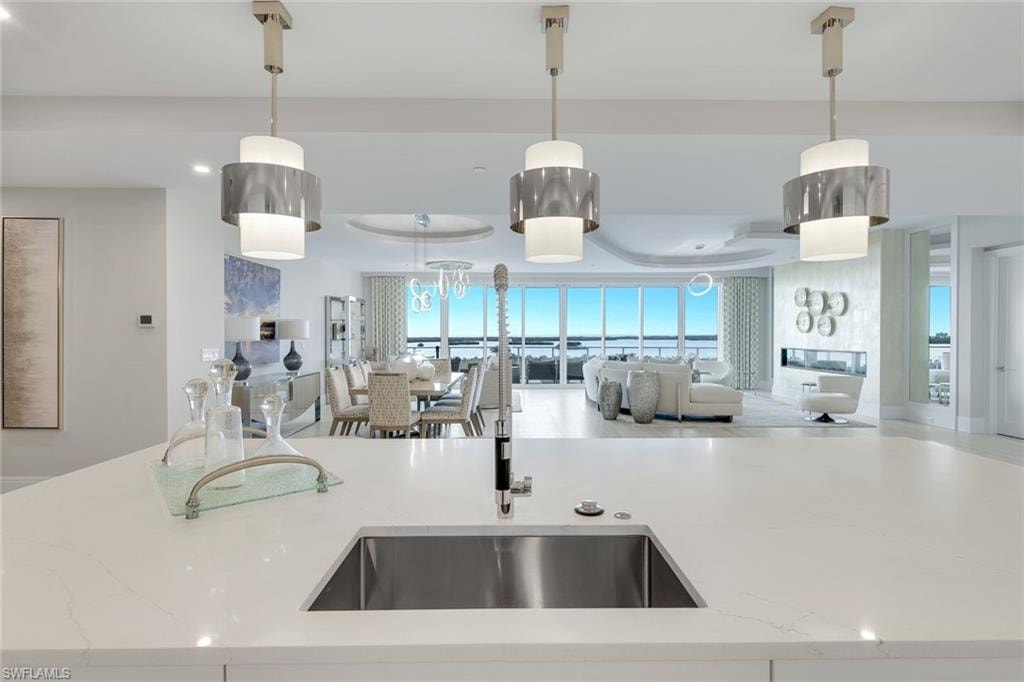Framed by panoramic Gulf views, the kitchen offers a stunning backdrop for even the simplest tasks.