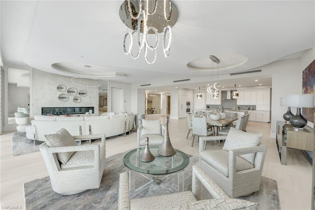 The dining, kitchen, and living areas transition fluidly, establishing a harmonious open layout.