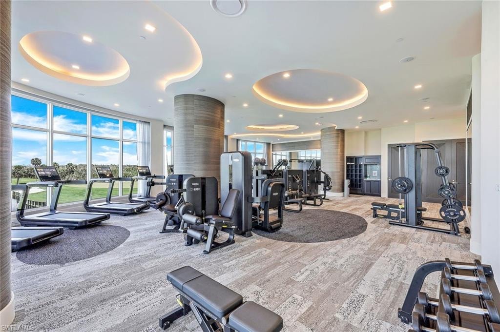 The fitness center offers inspiring vistas of the golf course and lake, enhancing every workout.