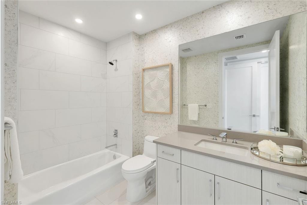An ensuite guest bath with a classic shower-tub combination.