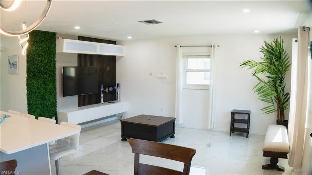 Living area featuring recessed lighting and baseboards
