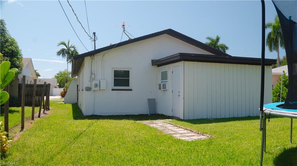 Back of house featuring a trampoline