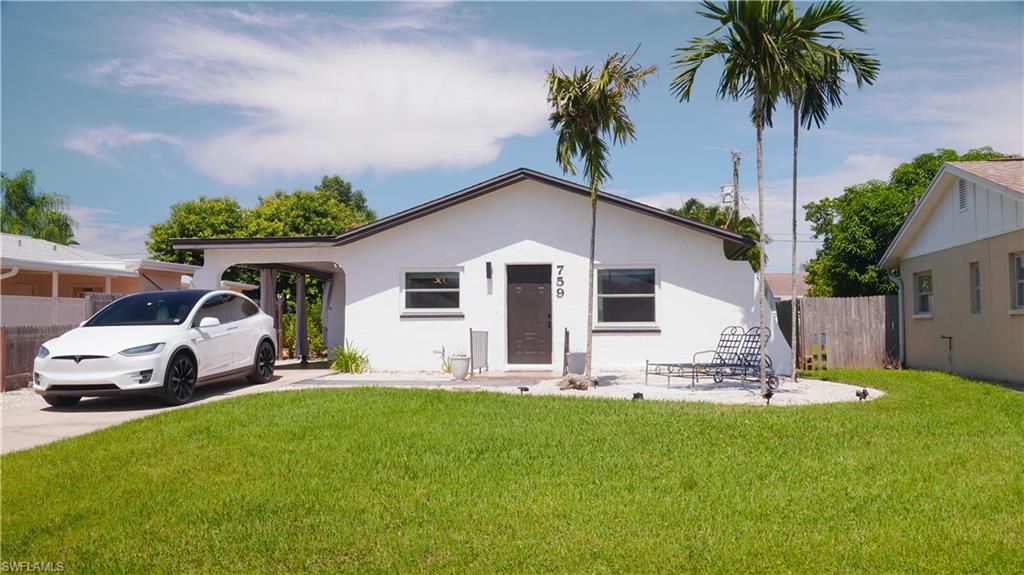 Bungalow-style house with stucco siding