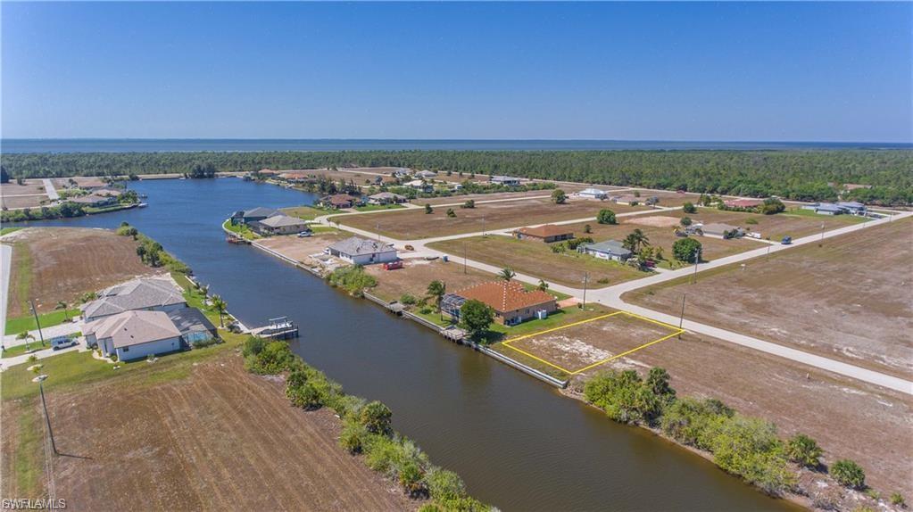 Aerial view of residential area featuring a large body of water
