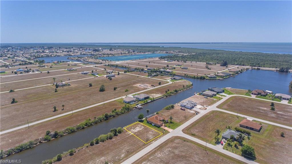 Aerial overview of property's location featuring a large body of water and property parcel outlined