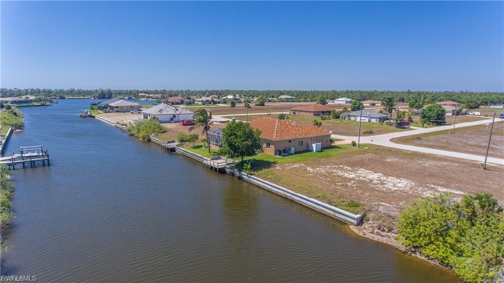 Aerial perspective of suburban area featuring a nearby body of water