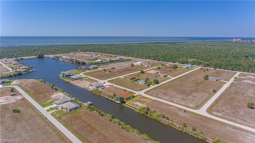 Aerial view of property's location with a nearby body of water