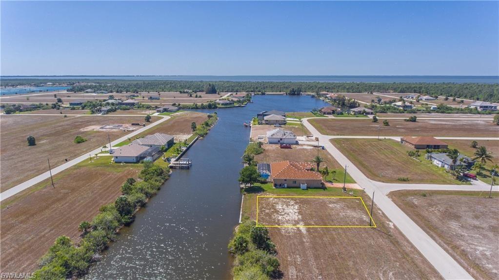 Aerial perspective of suburban area with a nearby body of water