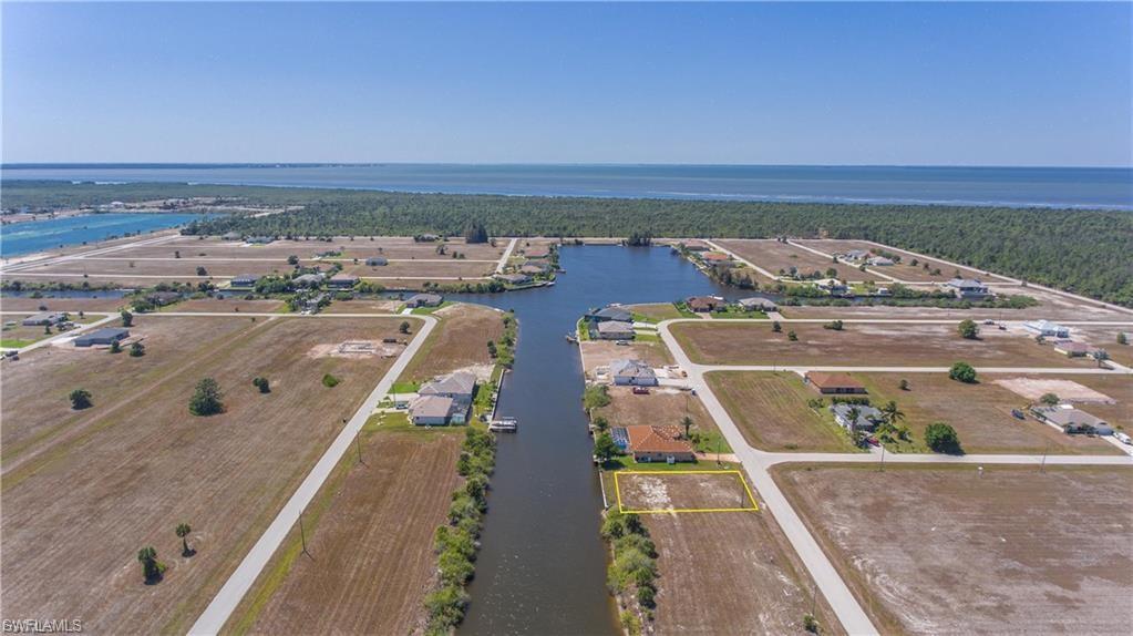 Drone / aerial view of a large body of water and a heavily wooded area