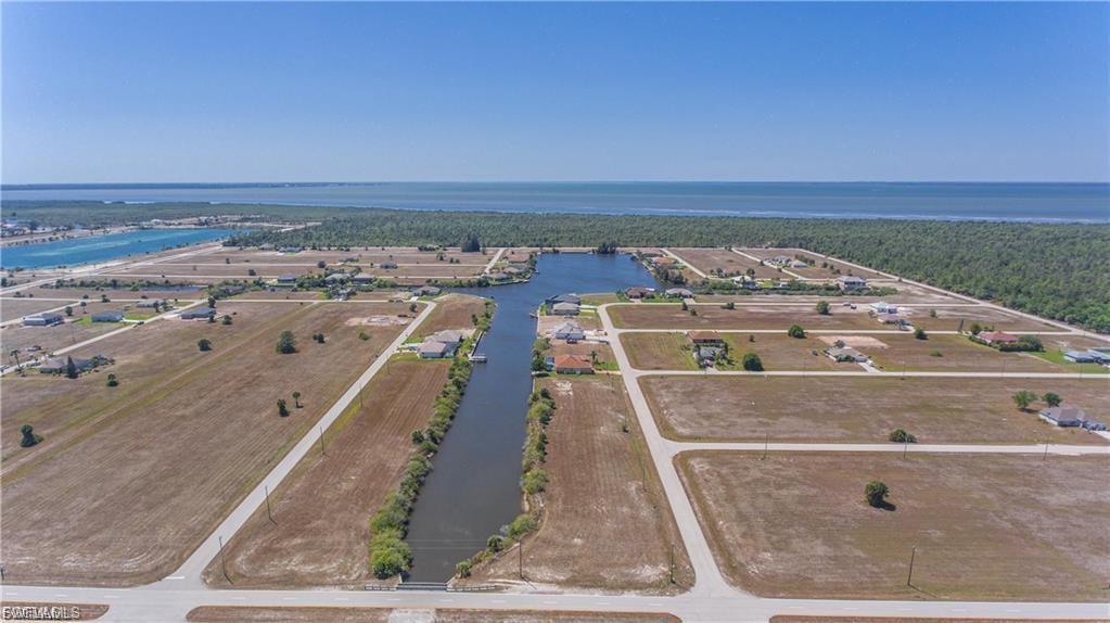 Aerial view of property's location with a large body of water