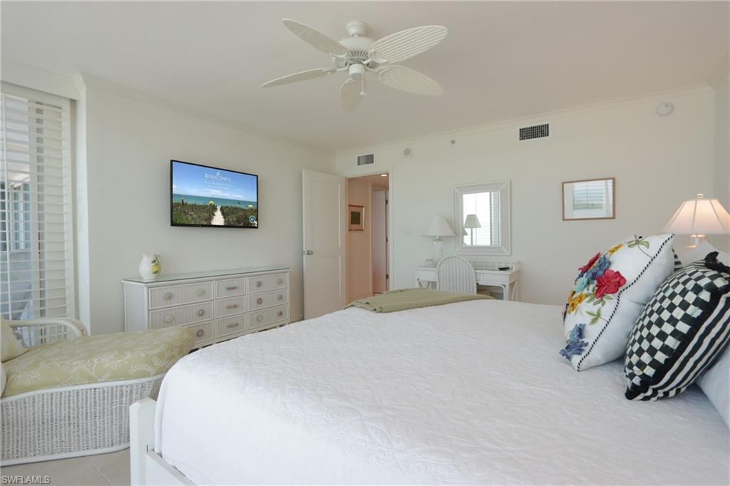 Bedroom with ceiling fan and crown molding