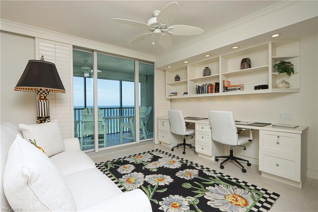 Office with crown molding, ceiling fan, and built in desk
