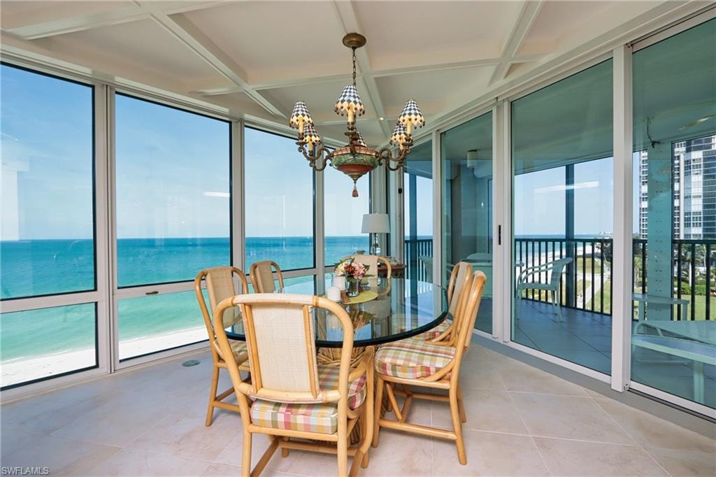 Sunroom / solarium with coffered ceiling and a water view