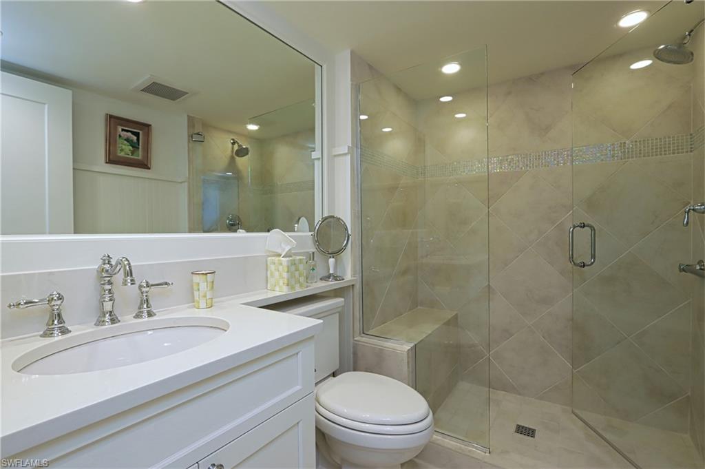 Bathroom featuring vanity, a stall shower, and recessed lighting