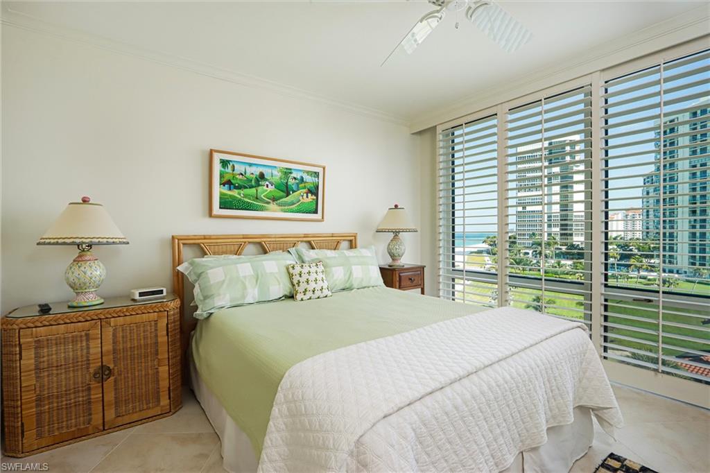 Bedroom featuring crown molding, ceiling fan, tile patterned floors, and a view of city