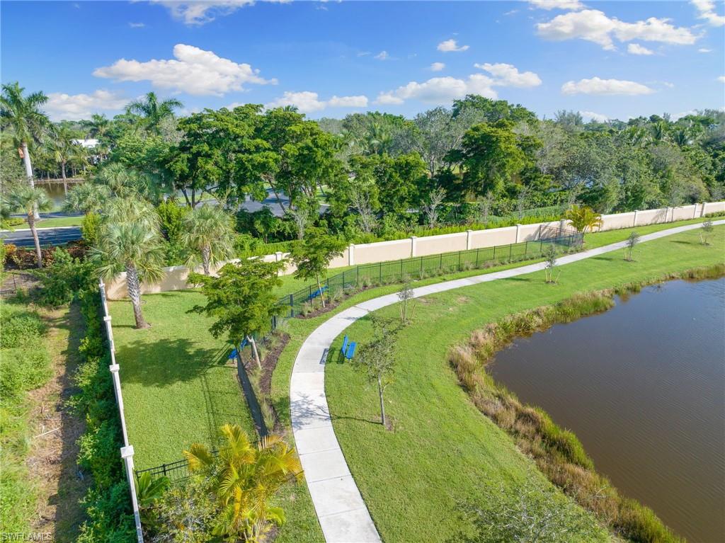 View of community with a water view and view of scattered trees