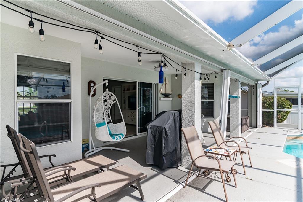 View of patio / terrace featuring glass enclosure, a sunroom, an outdoor pool, and a grill