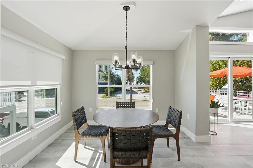 Dining room featuring suspended lighting and baseboards - Virtually Edited Image